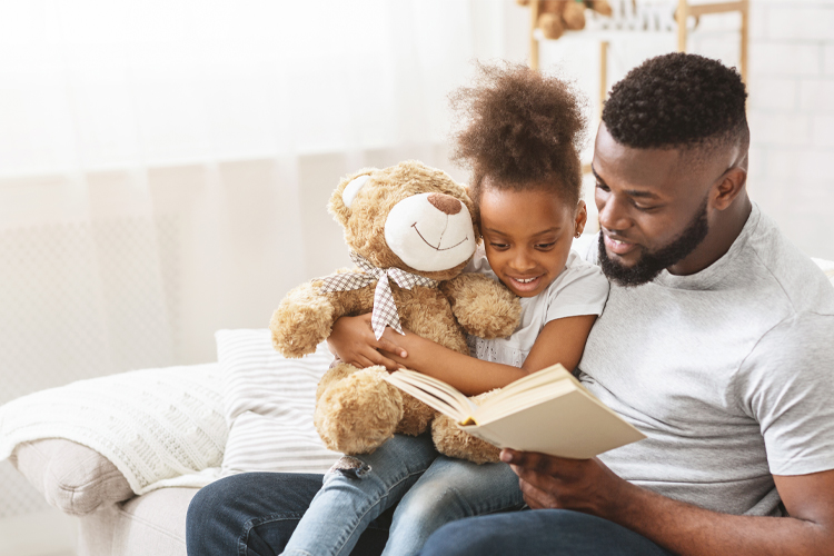 black dad reading to child